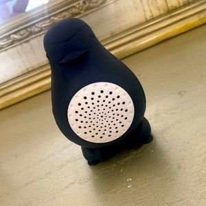A speaker that is in the shape of a penguin